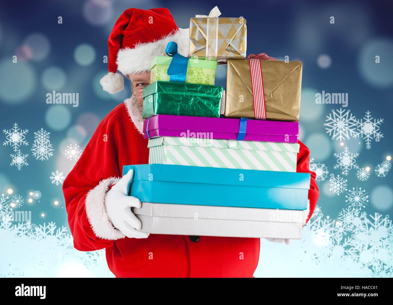Santa claus hiding behind stack of gifts Stock Photo