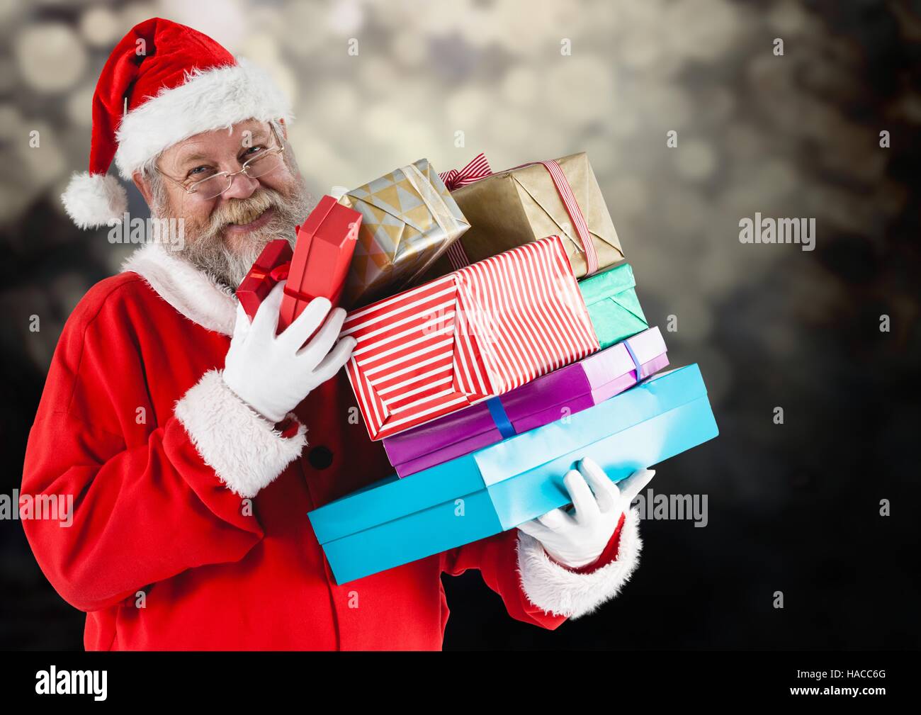 Happy santa holding stack of gifts boxes Stock Photo - Alamy