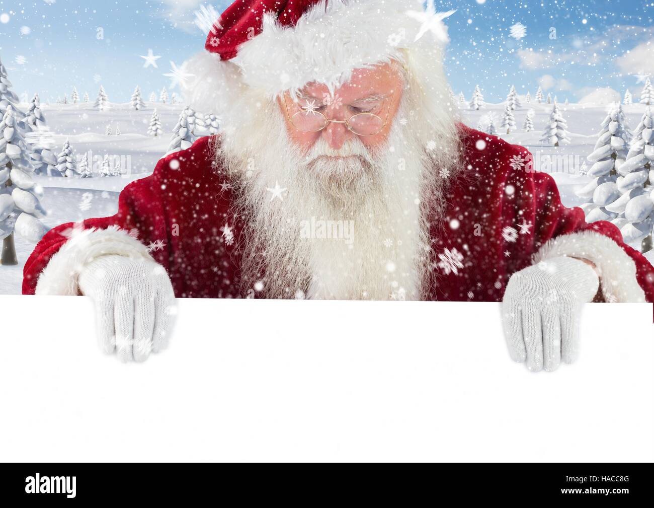 Santa claus looking down at white placard 3D Stock Photo