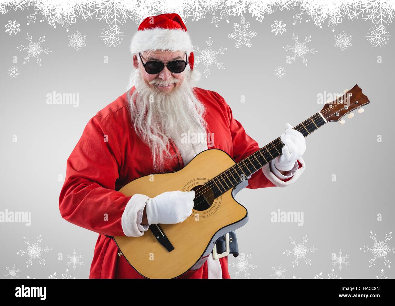 Santa claus in sunglasses playing guitar Stock Photo