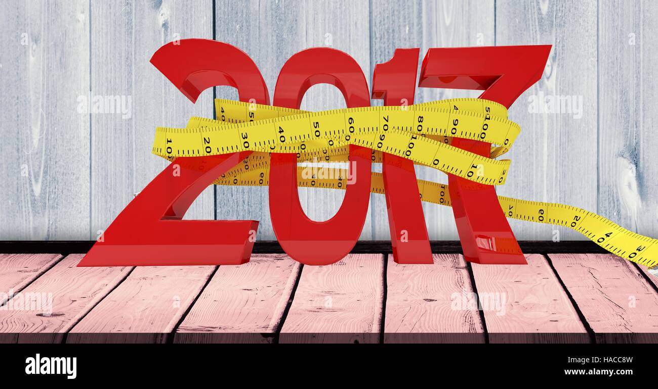 2017 wrapped with measure tape on wooden plank against a composite image 3D of background Stock Photo