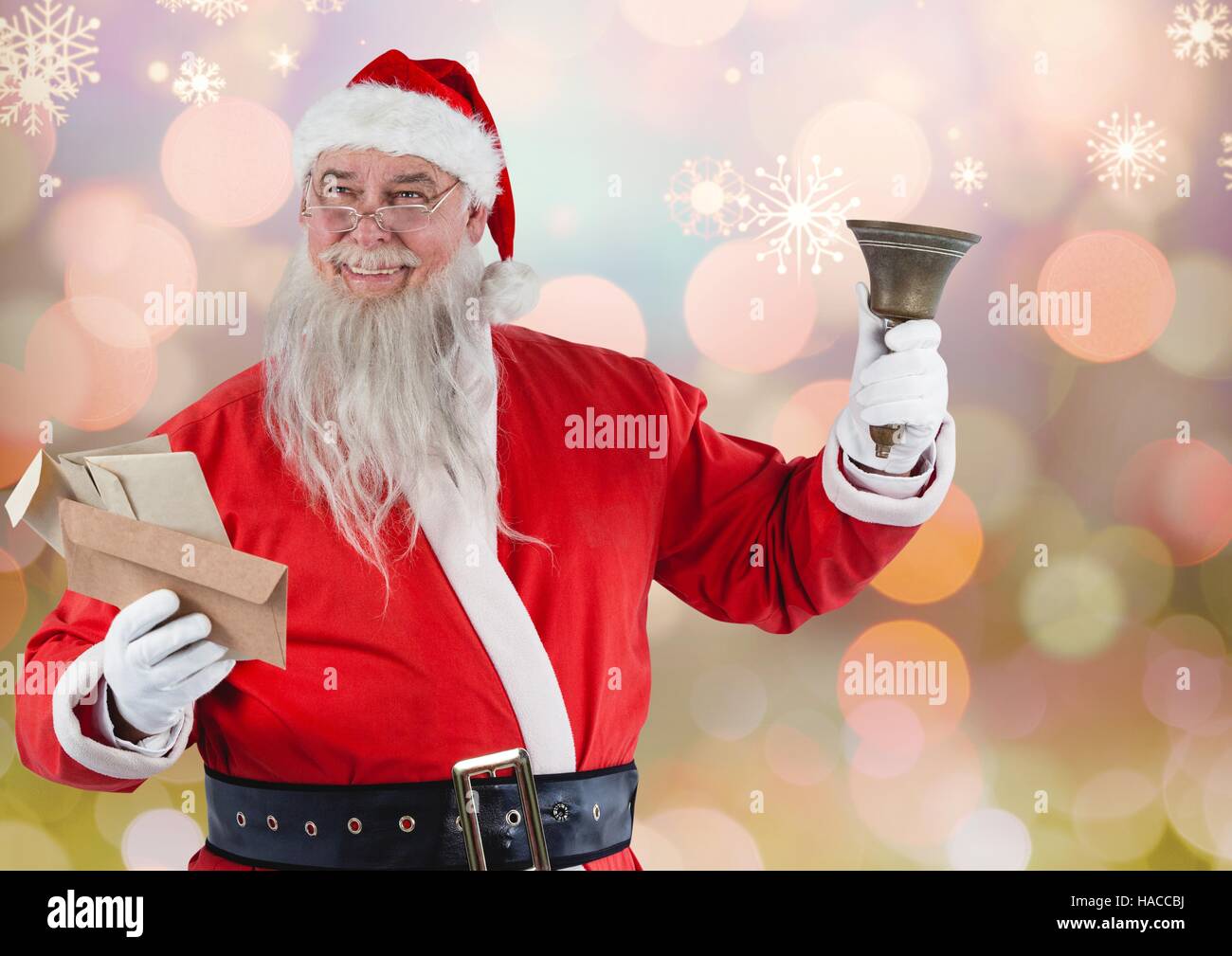 Santa claus holding envelopes and christmas bell Stock Photo