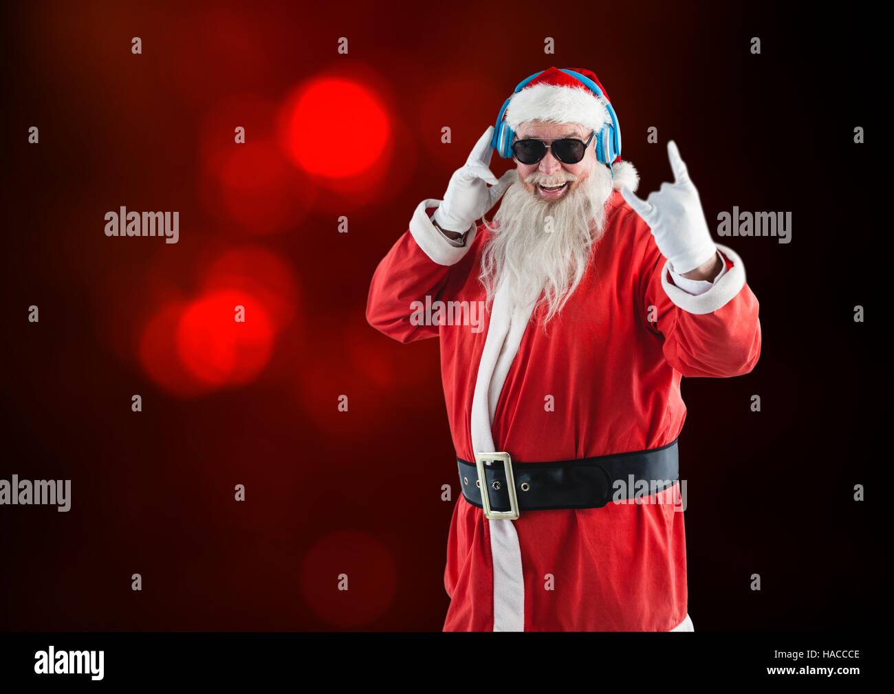 Rock n roll santa claus listening to music on headphones Stock Photo