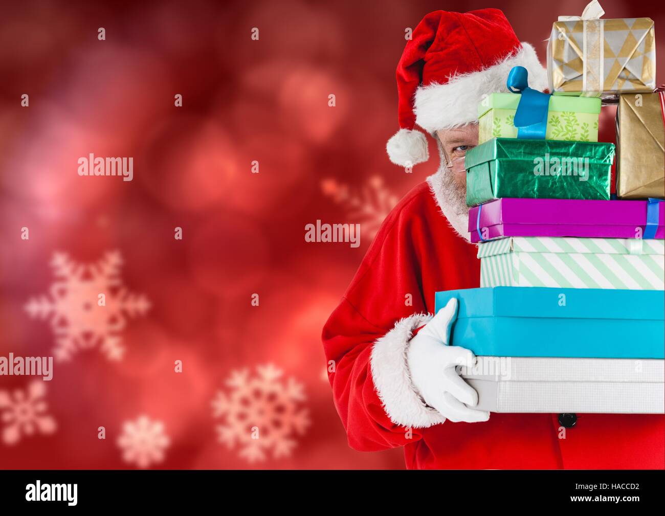 Santa claus holding stack of christmas gifts Stock Photo