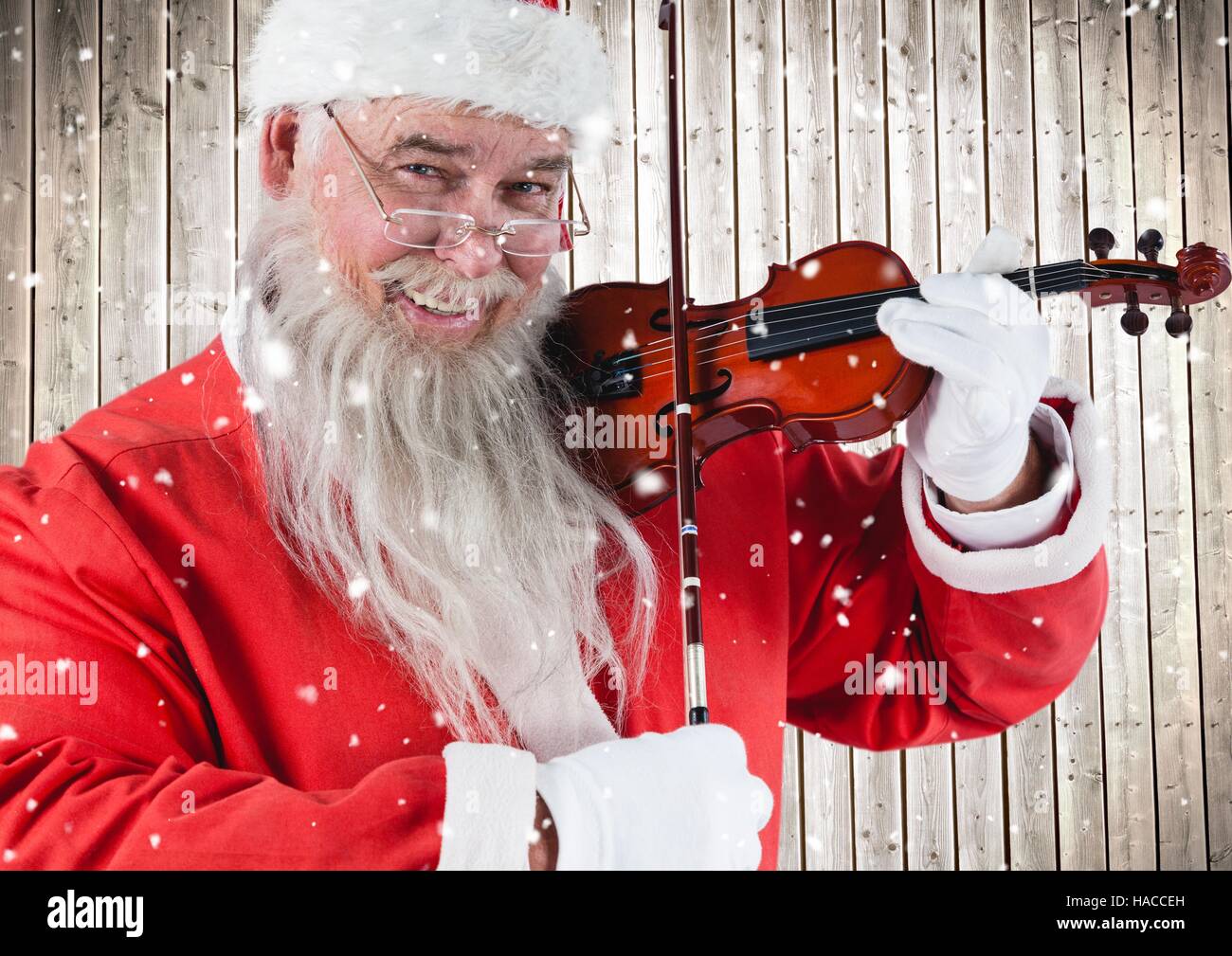 Happy santa playing violin Stock Photo