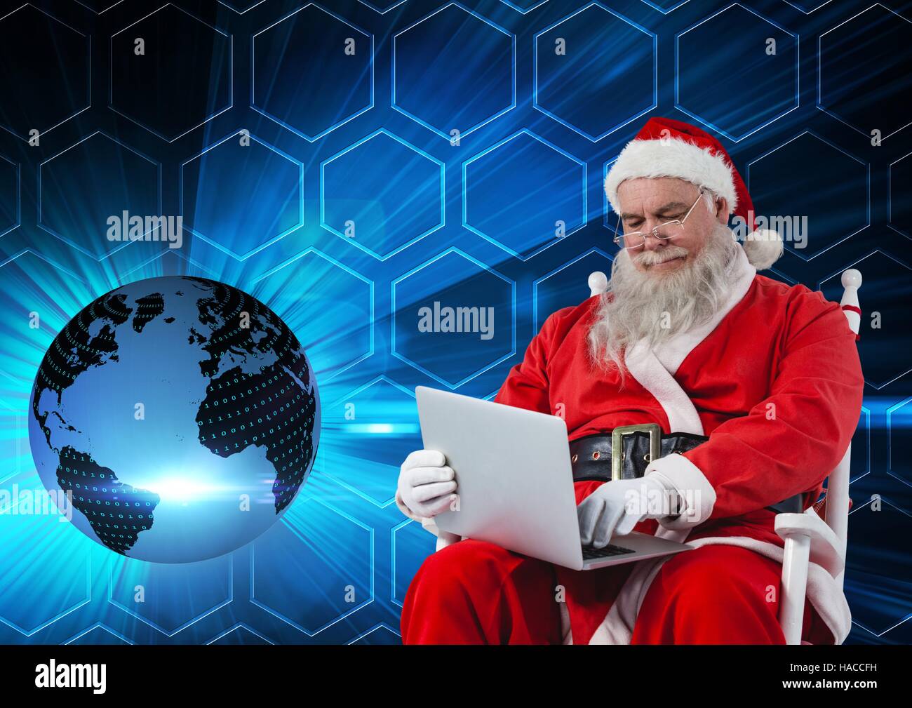 Santa sitting on chair and using laptop 3D Stock Photo