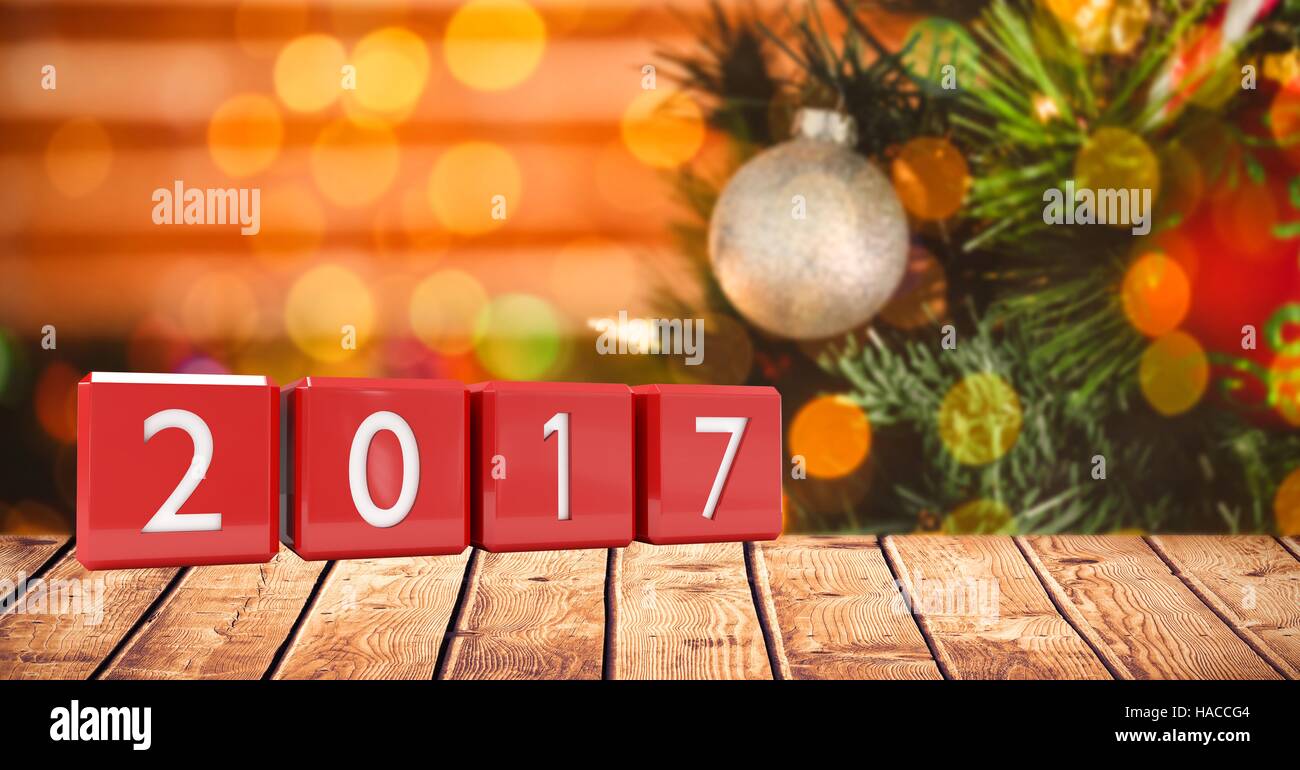 2017 in blocks on wooden plank against a composite image 3D of christmas background Stock Photo