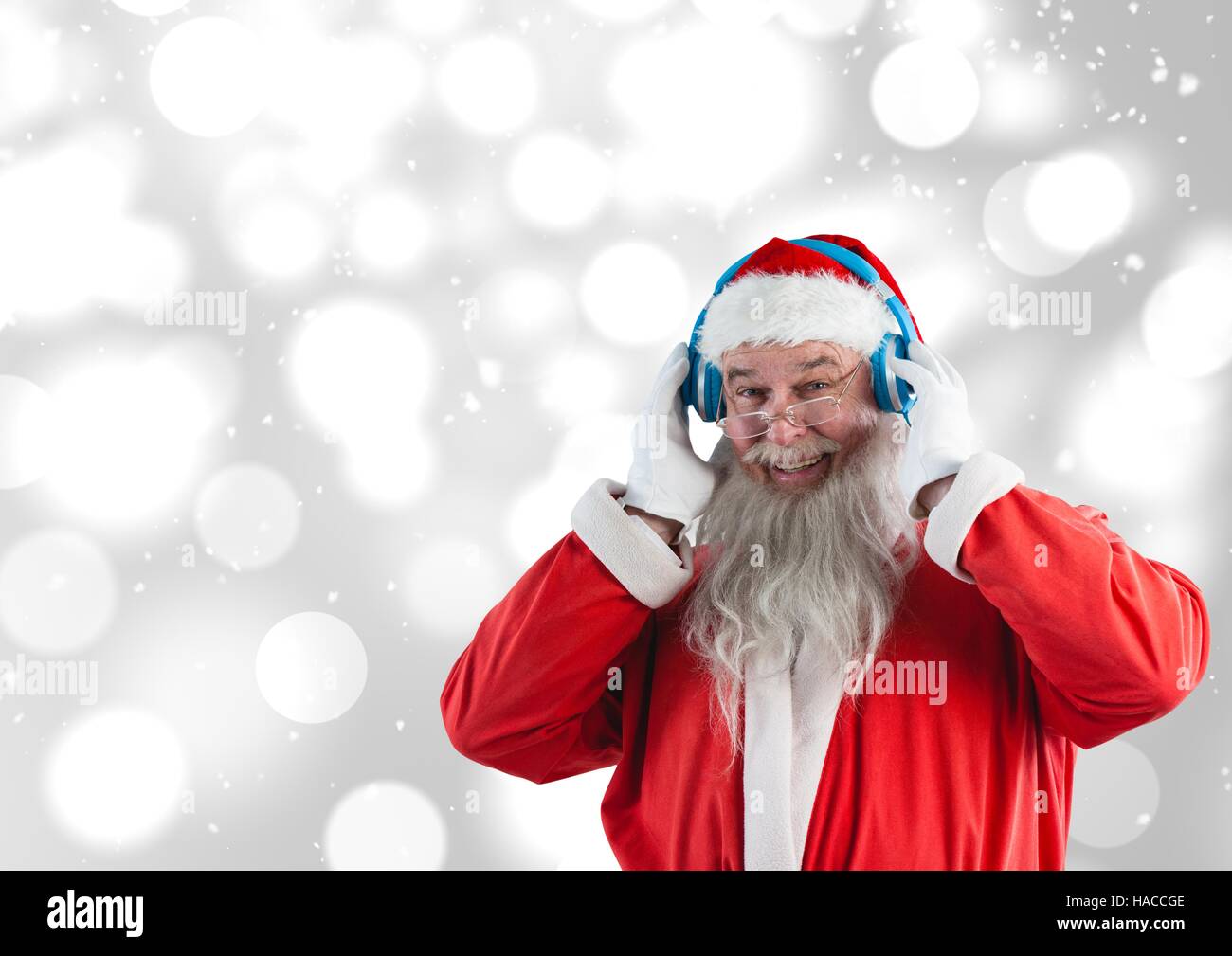 Santa listening music on headphones Stock Photo