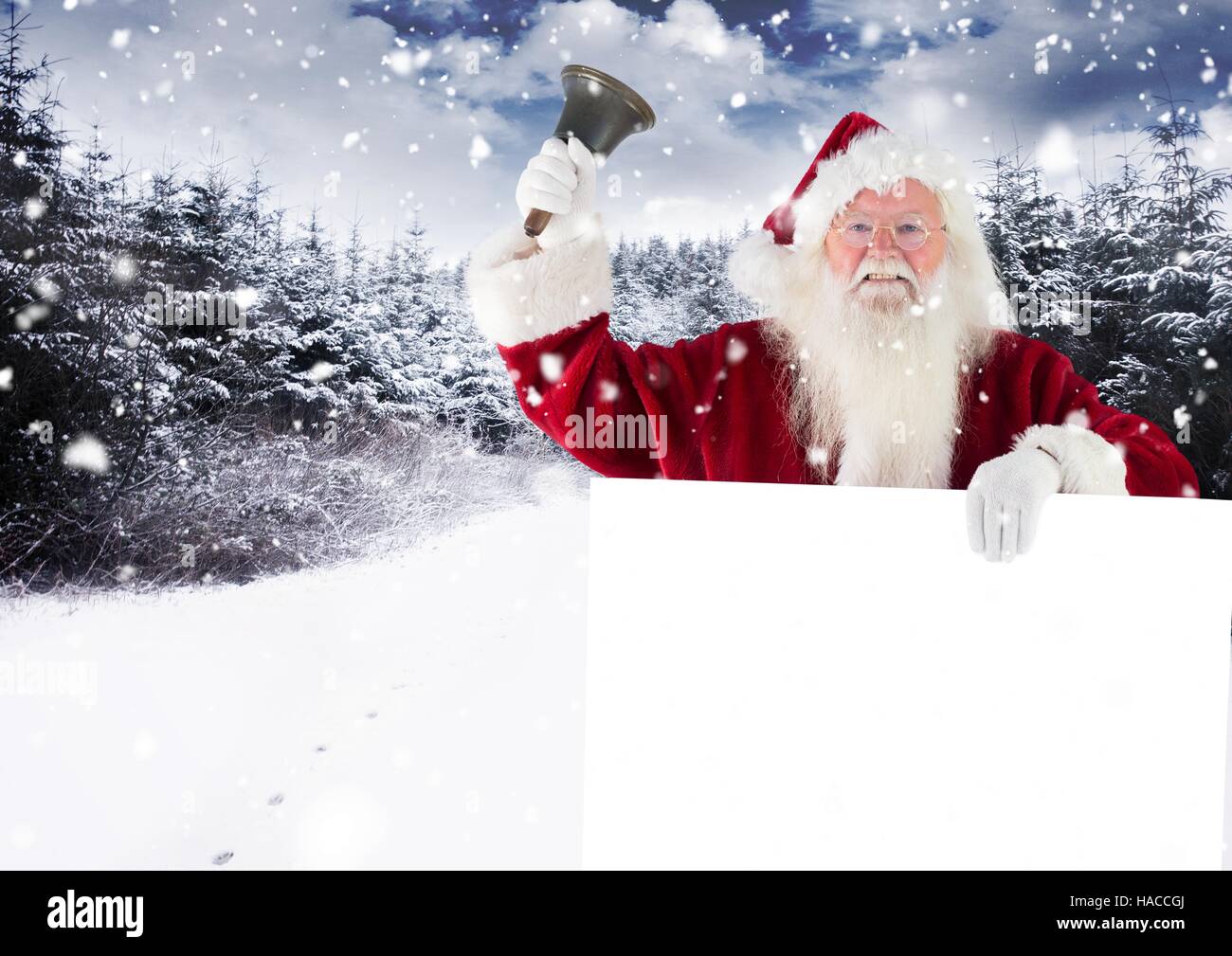 Santa claus ringing a bell while holding placard Stock Photo