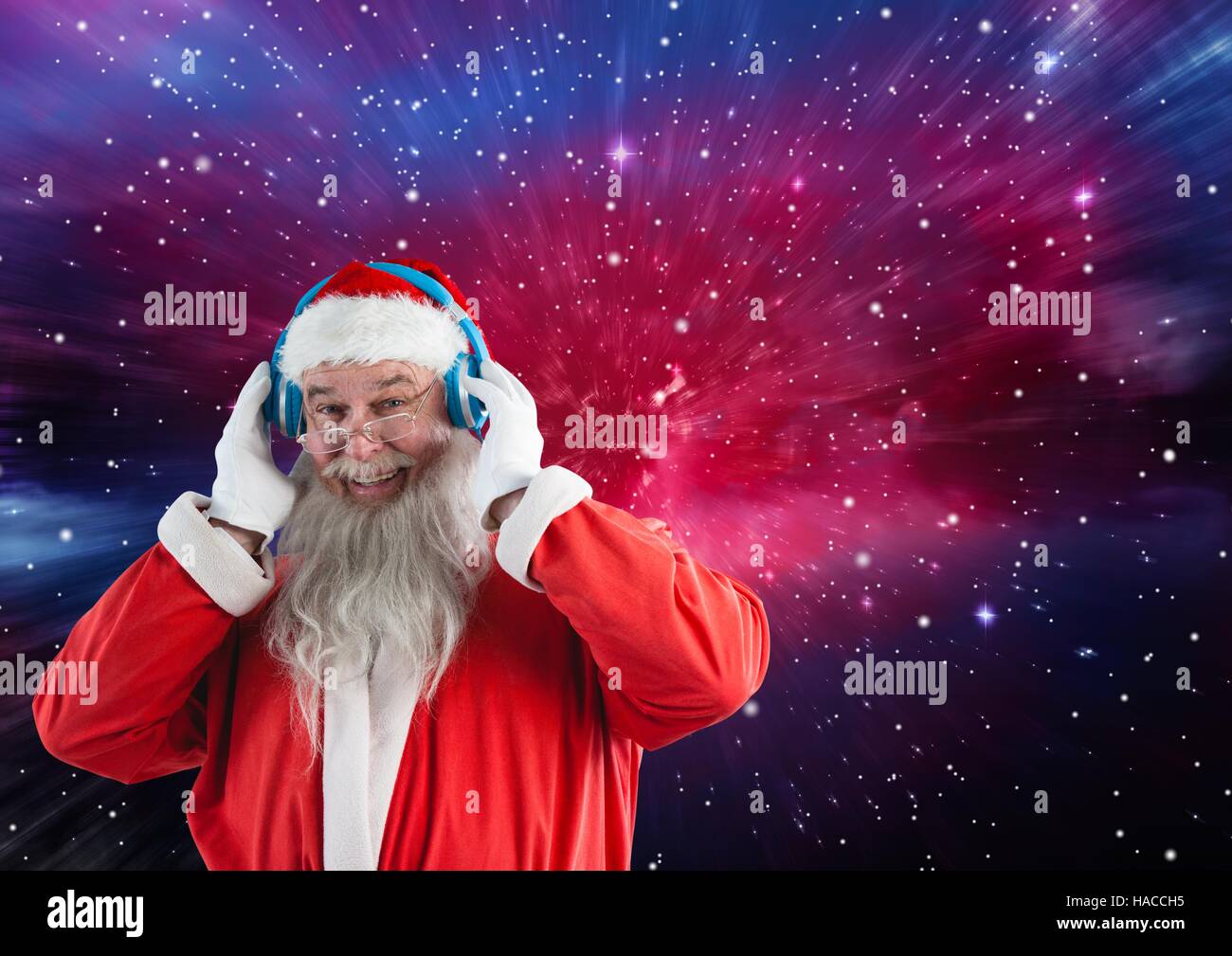 Happy santa claus listening music on headphones Stock Photo