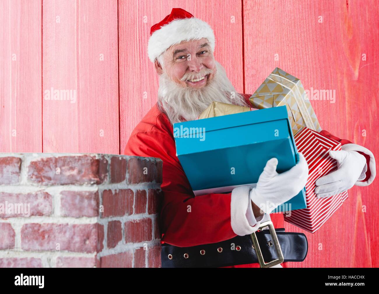 Smiling santa claus holding gift boxes Stock Photo