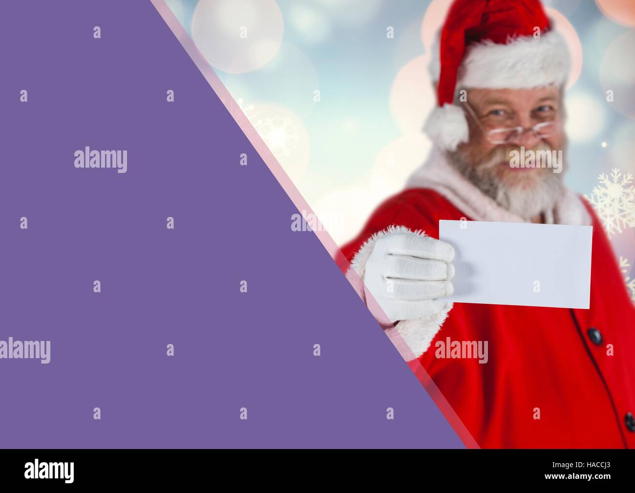 Santa claus holding a white card Stock Photo
