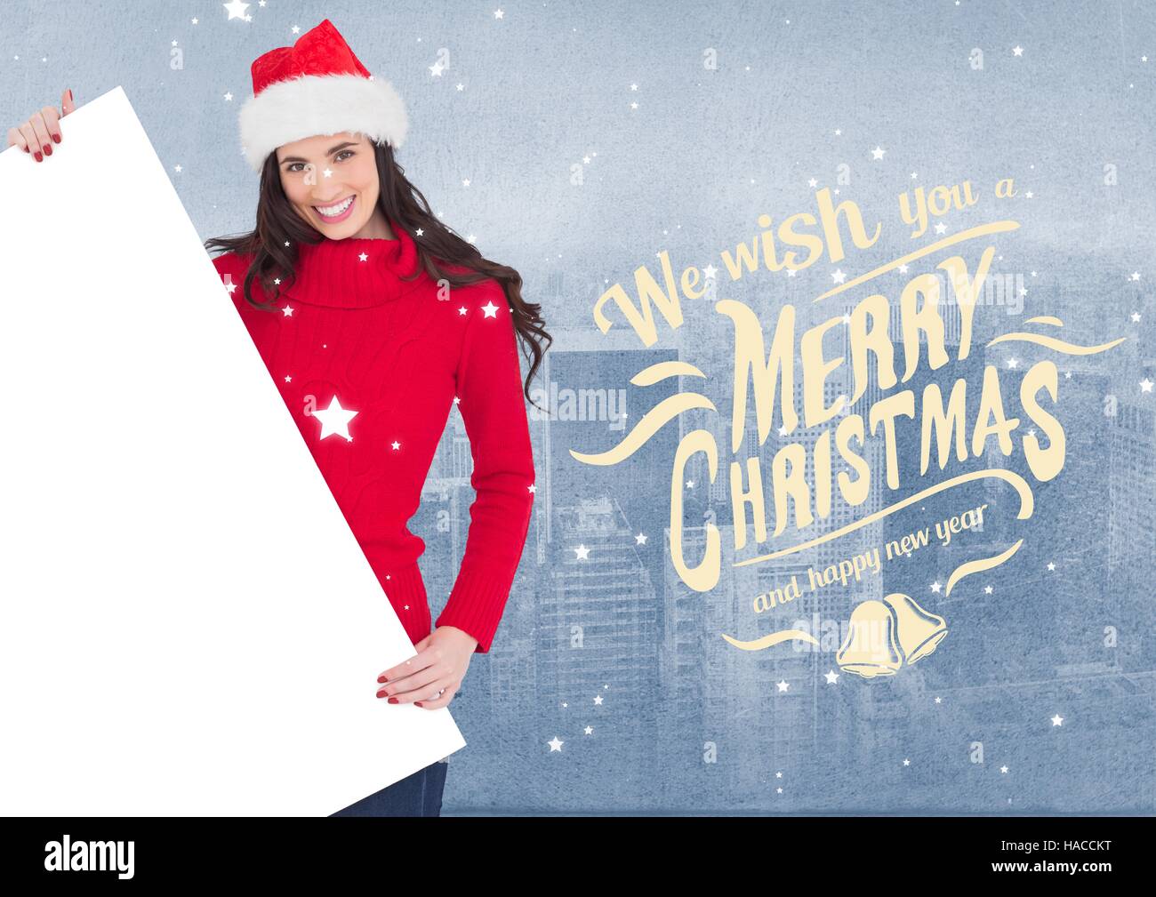 Merry christmas wishes and woman in santa hat holding a blank placard Stock Photo