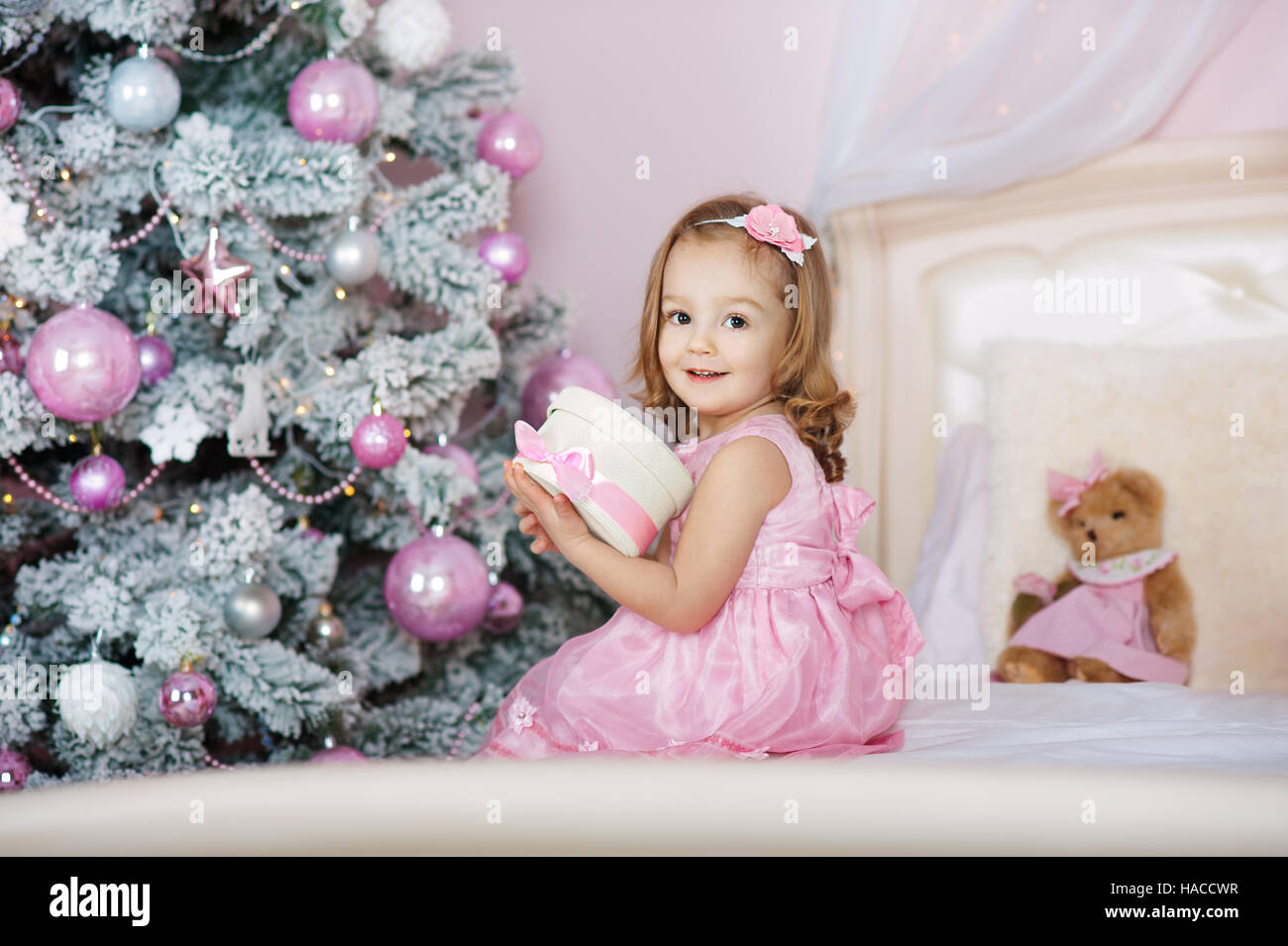 Happy little smiling girl with christmas gift box Stock Photo - Alamy