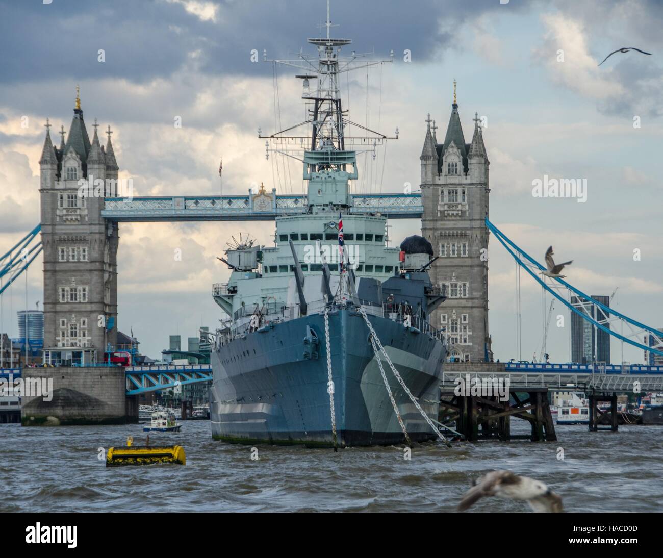 The HMS Belfast in front of Tower Bridge, London, England, UK Stock Photo