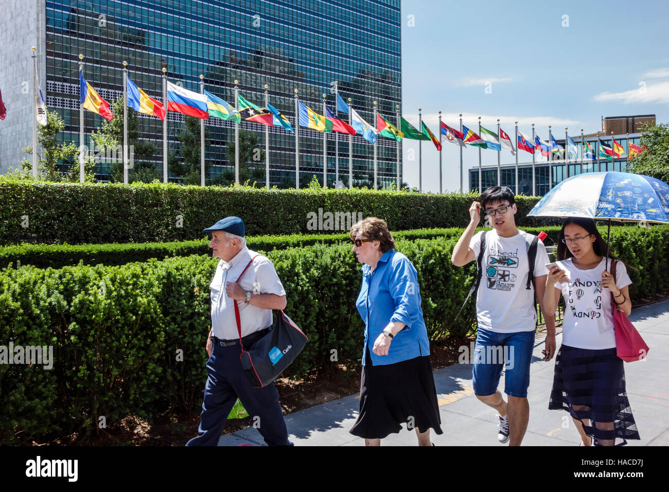 New York City,NY NYC Manhattan,Midtown,Turtle Bay,United Nations Headquarters,exterior,flags,Asian adult,adults,man men male,woman female women,senior Stock Photo