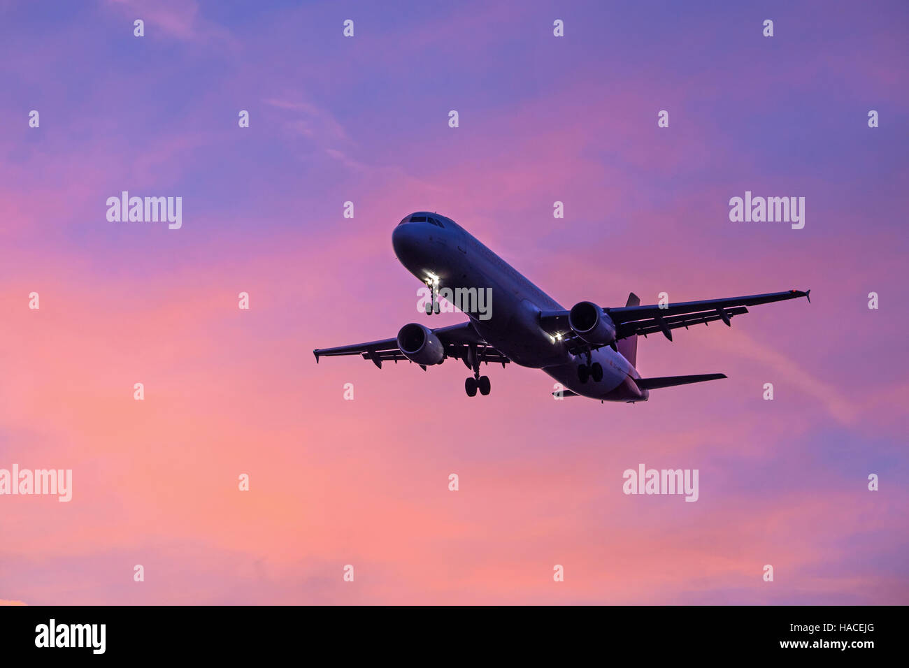 Plane landing during Sunset, at London Heathrow Airport Stock Photo
