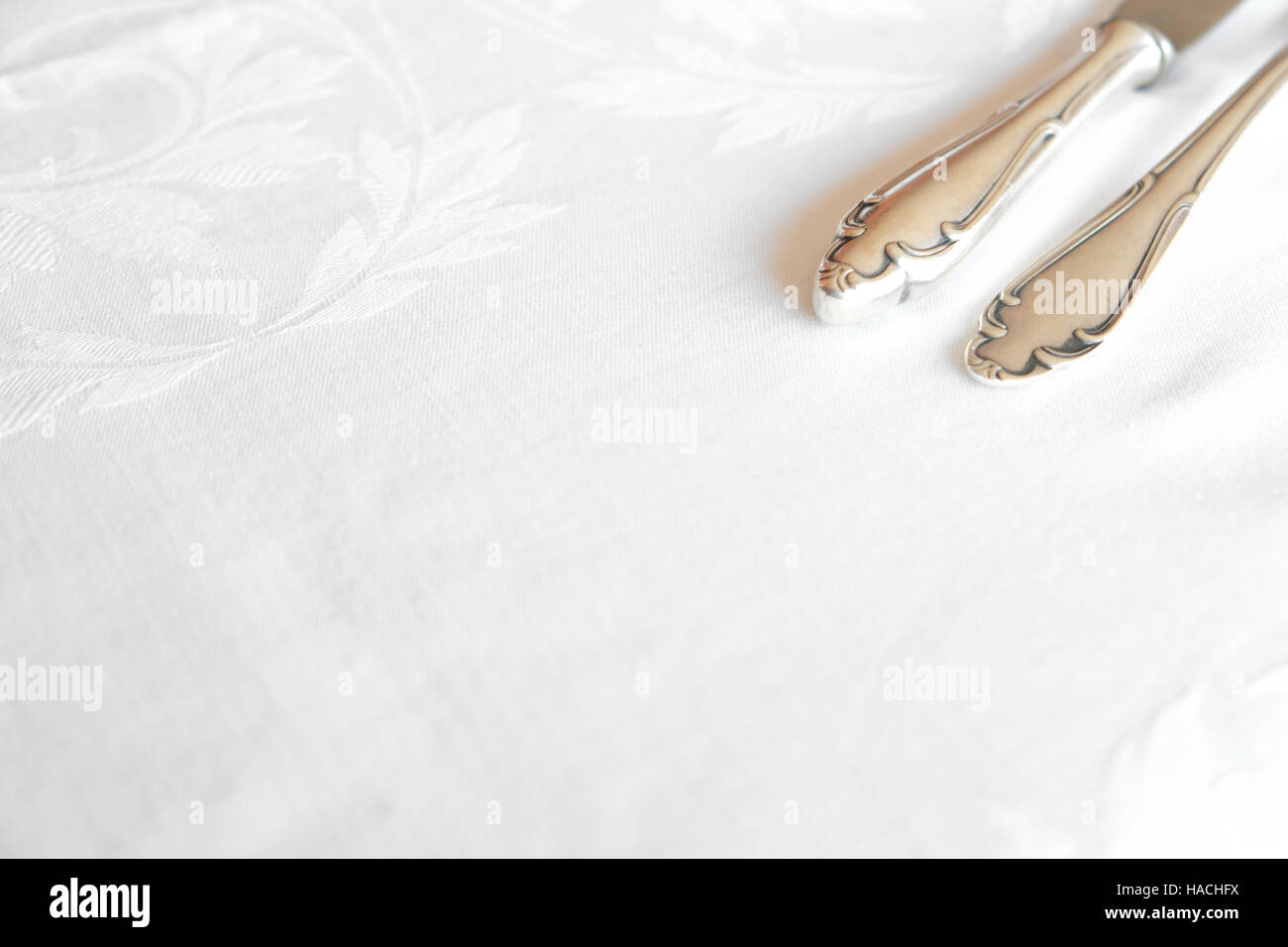 white tablecloth with cutlery set, knife and fork Stock Photo