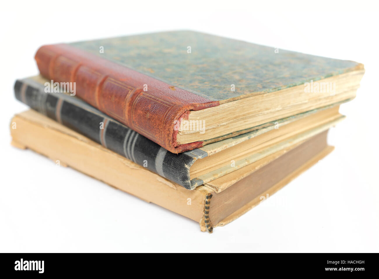 three old  books stacked on white table Stock Photo