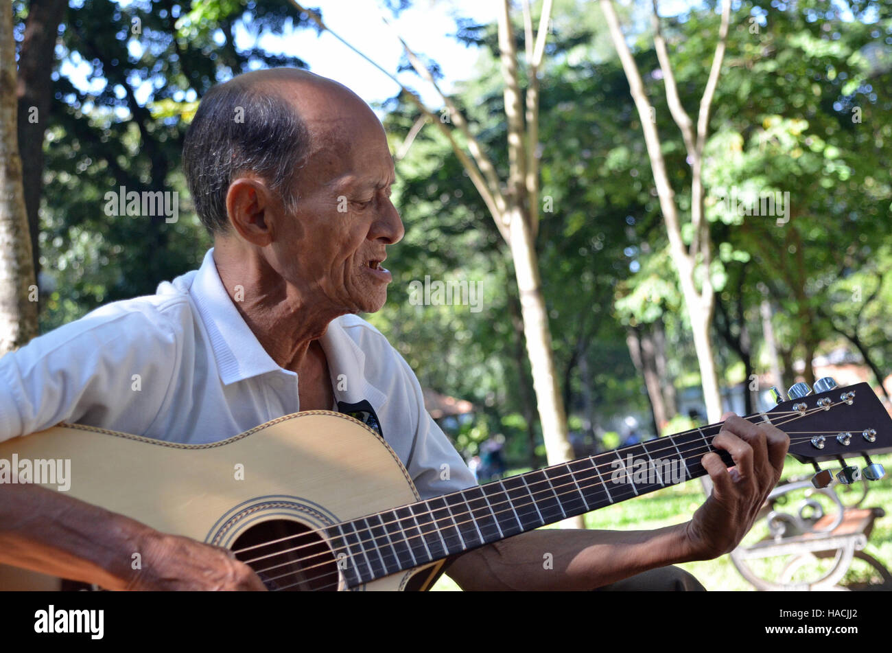 Old man singing and playing the guitar Stock Photo