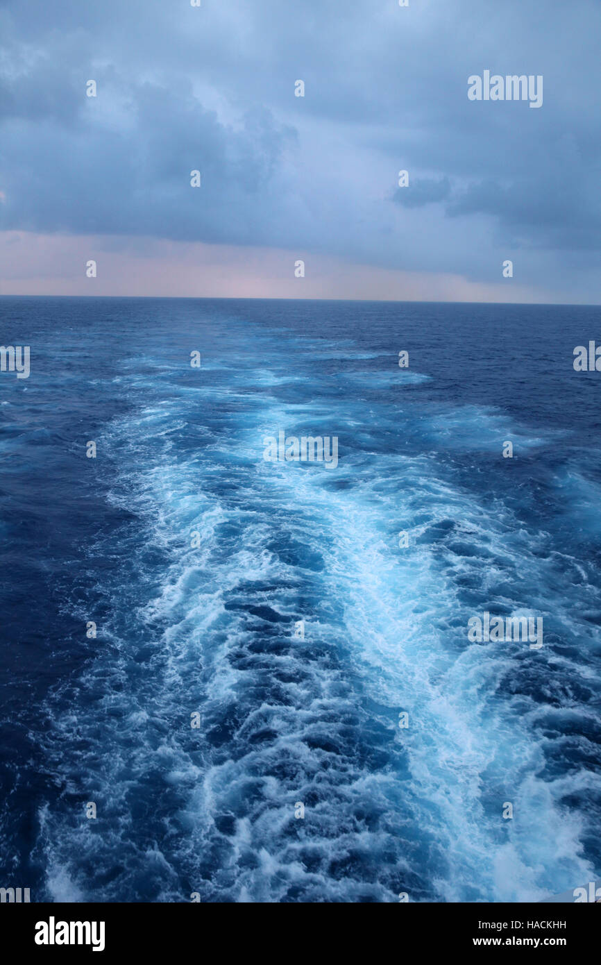 Ships wake in the ocean with swell & stormy skies, Atlantic Ocean. Stock Photo