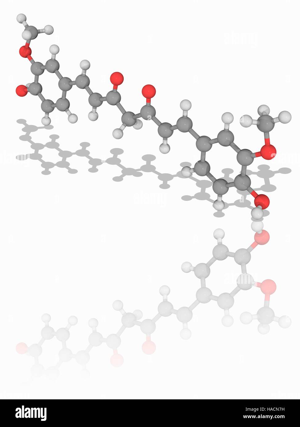 Curcumin. Molecular model of the food colouring and food additive curcumin (C21.H20.O6). This is the principal active ingredient of the Indian spice turmeric. Its E number is E100. Atoms are represented as spheres and are colour-coded: carbon (grey), hydrogen (white) and oxygen (red). Illustration. Stock Photo