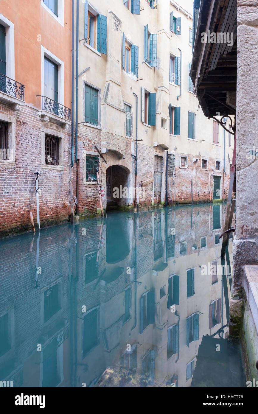 Reflection in the calm water of a canal, Venice, Italy Stock Photo - Alamy