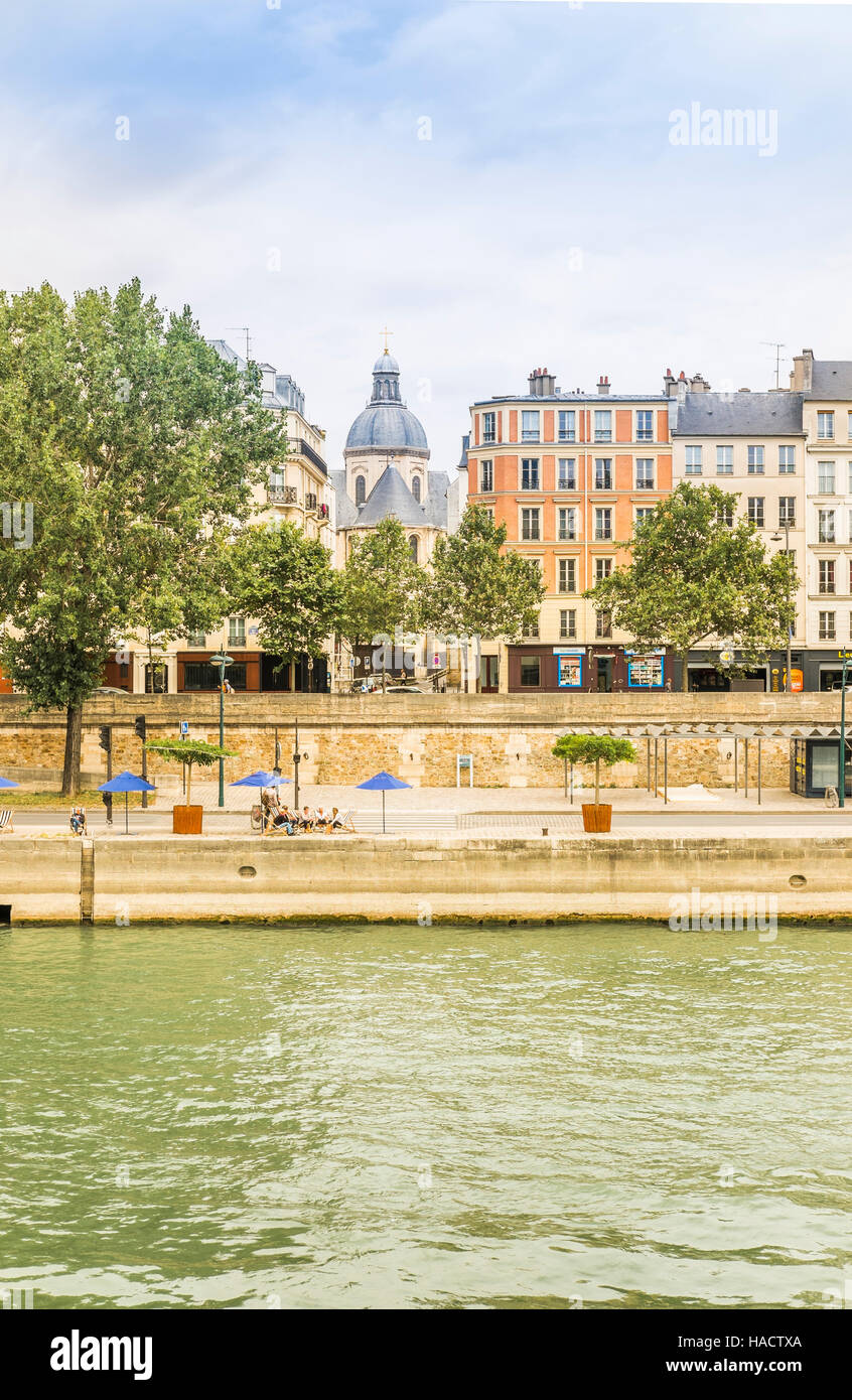 people taking a break under blue  paris plage  umbrellas on the banks of river seine Stock Photo