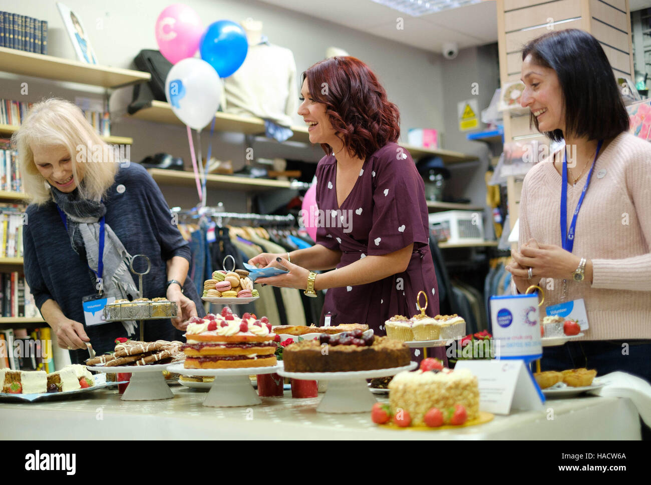 EDITORIAL USE ONLY Candice Brown (centre), winner of the Great British Bake Off, joins volunteers at a charity bake sale to celebrate Giving Tuesday, which is an alternative to Black Friday with people around the world being encouraged to do a good deed for charity. Stock Photo