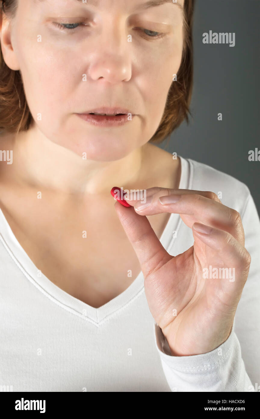 Close up of woman taking in pill. Medicine, health care concept. Stock Photo