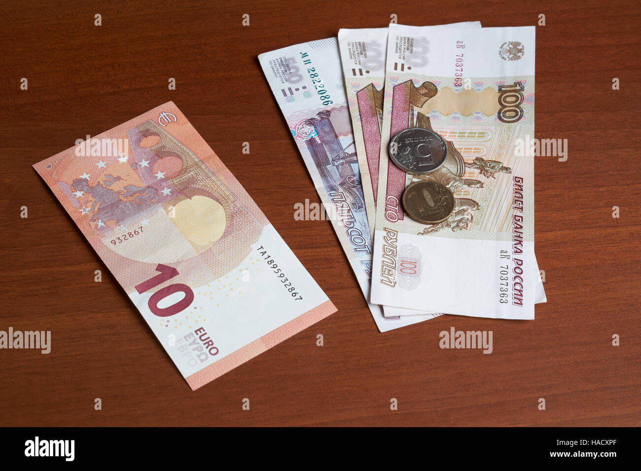 Euro and ruble banknotes and coins at current approximate exchange rate on the office table Stock Photo