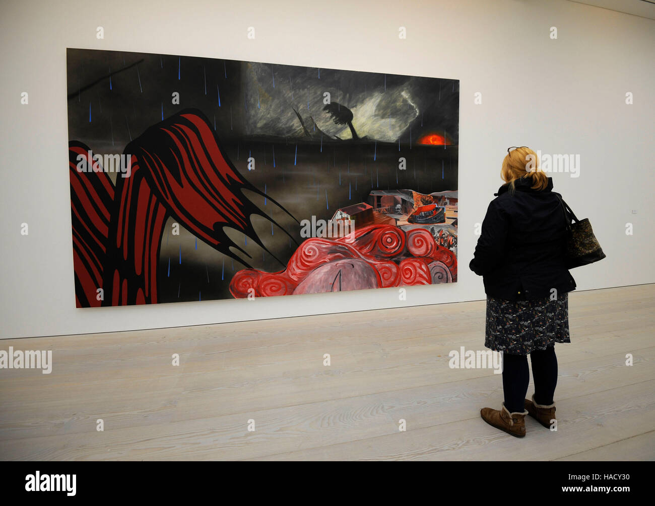 A woman views a painting titled The Deluge by Dexter Dalwood displayed at a photo call and press view for the Saatchi Gallery's winter exhibition Painters' Painters at the gallery in Chelsea, west London. Stock Photo