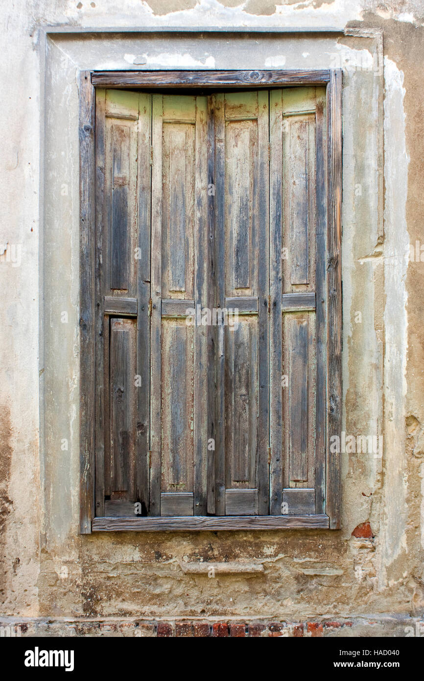 Window with aged shutters on old house in Croatia Stock Photo