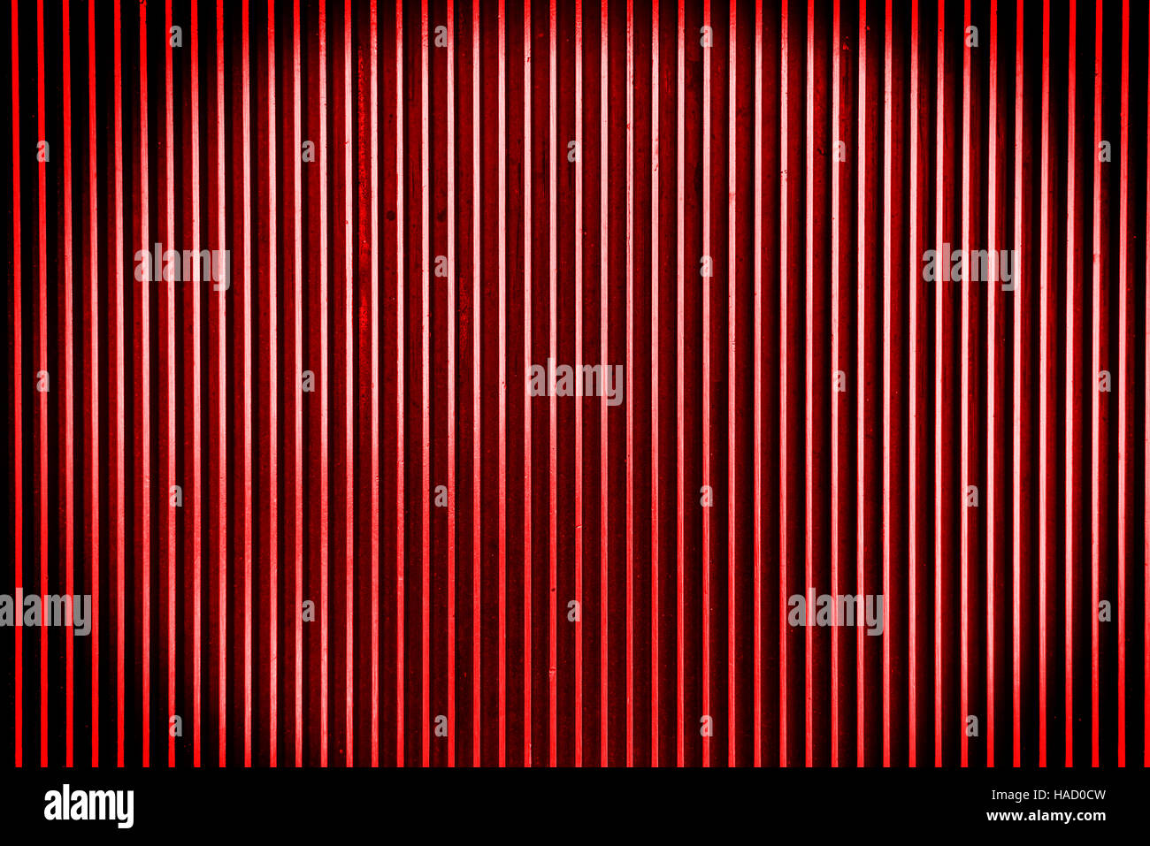 Red metal steel background with bright center spotlight and black