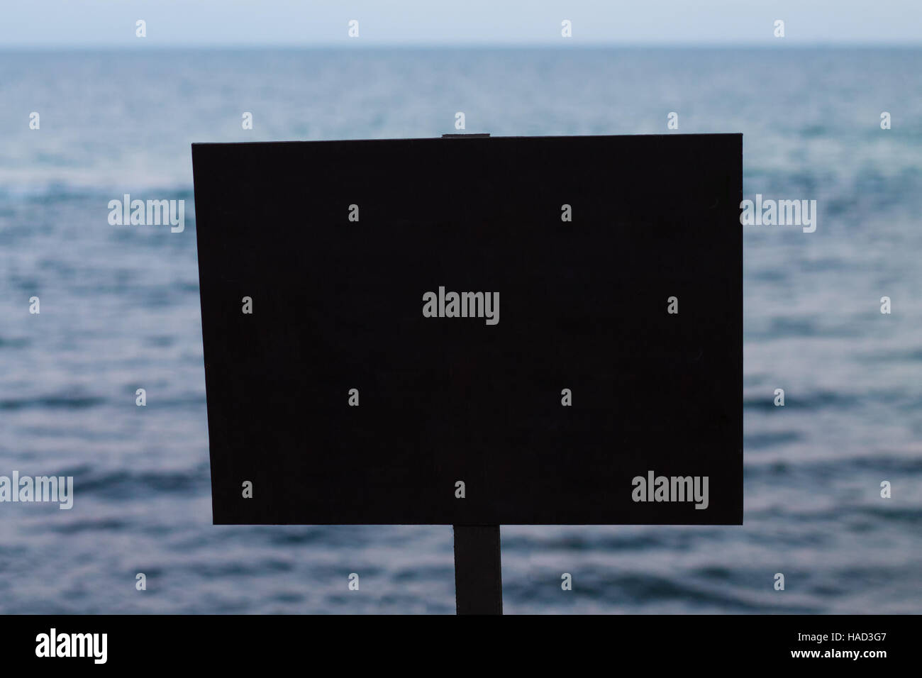 Empty black rectangular sign with sea on the background Stock Photo