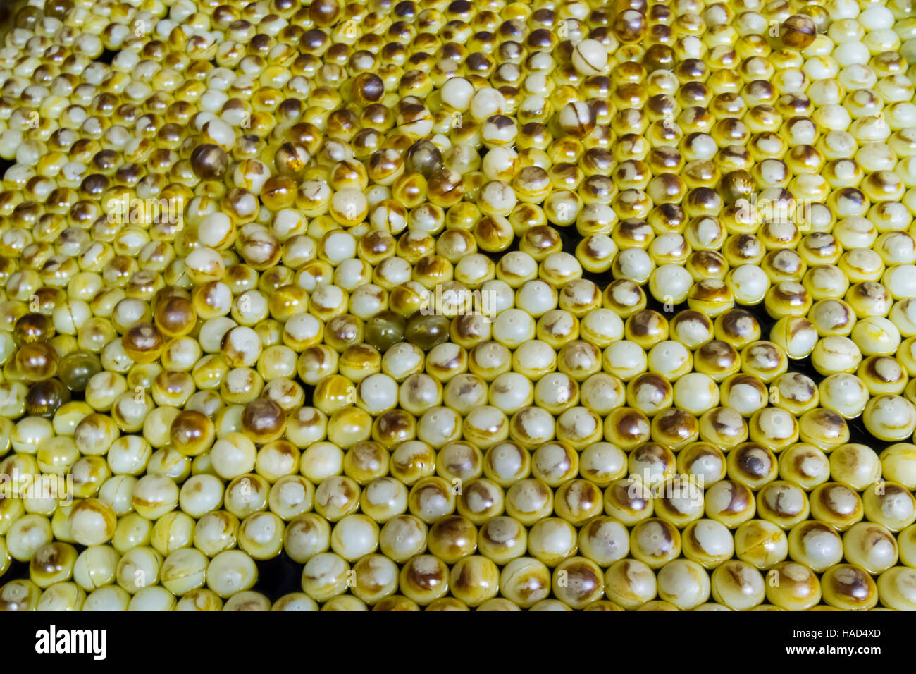 Ping pong balls floating in acid bath. Stock Photo