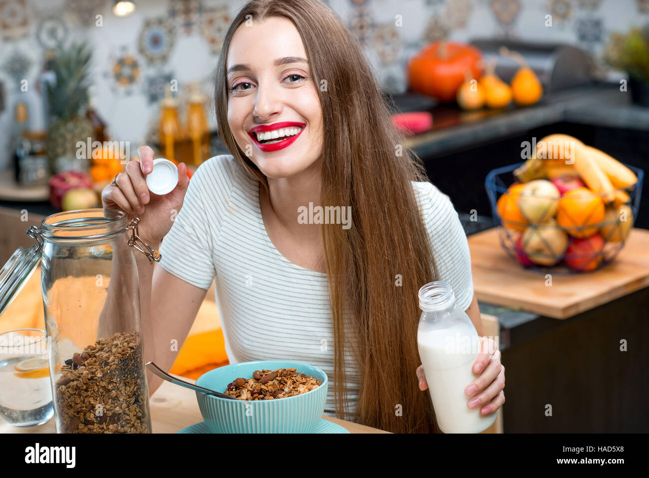 Woman with granola breakfast in the kitchen Stock Photo Alamy