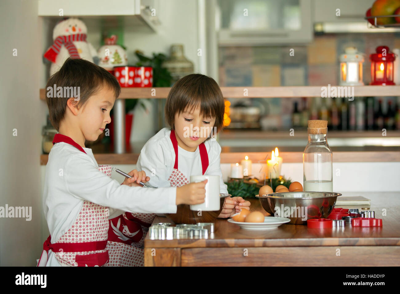 Two Sweet Children Boy Brothers Preparing Gingerbread Cookies For two-sweet-children-boy-brothers-preparing-gingerbread-cookies-for