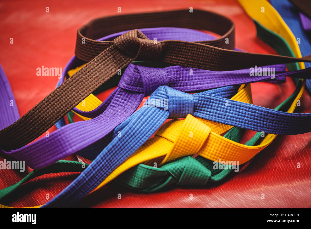 Multicoloured karate belts on red background Stock Photo - Alamy