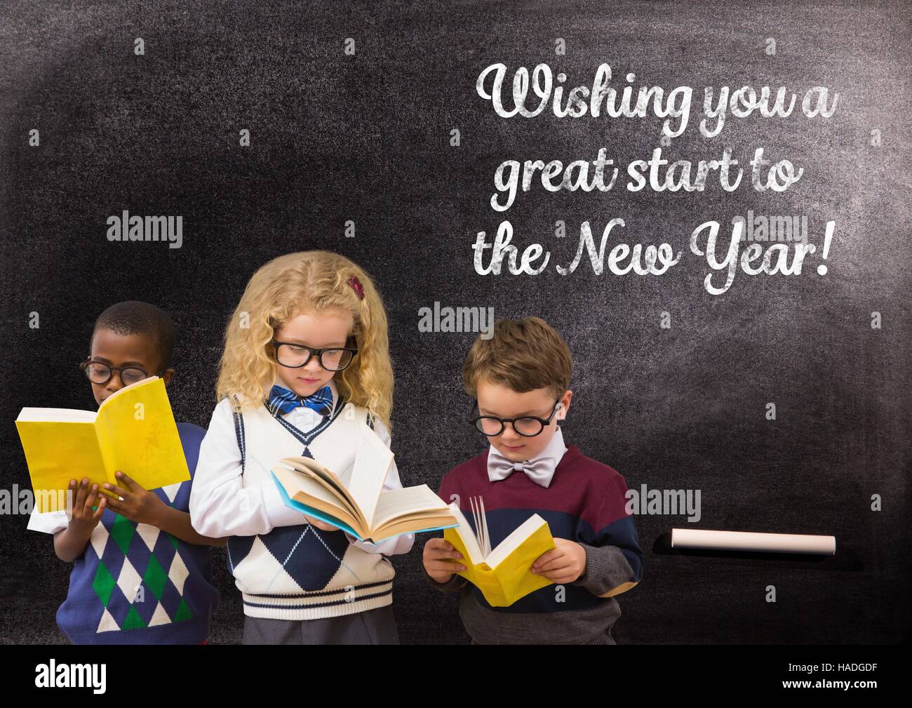 Children reading books against blackboard with 2017 new year greeting quotes Stock Photo