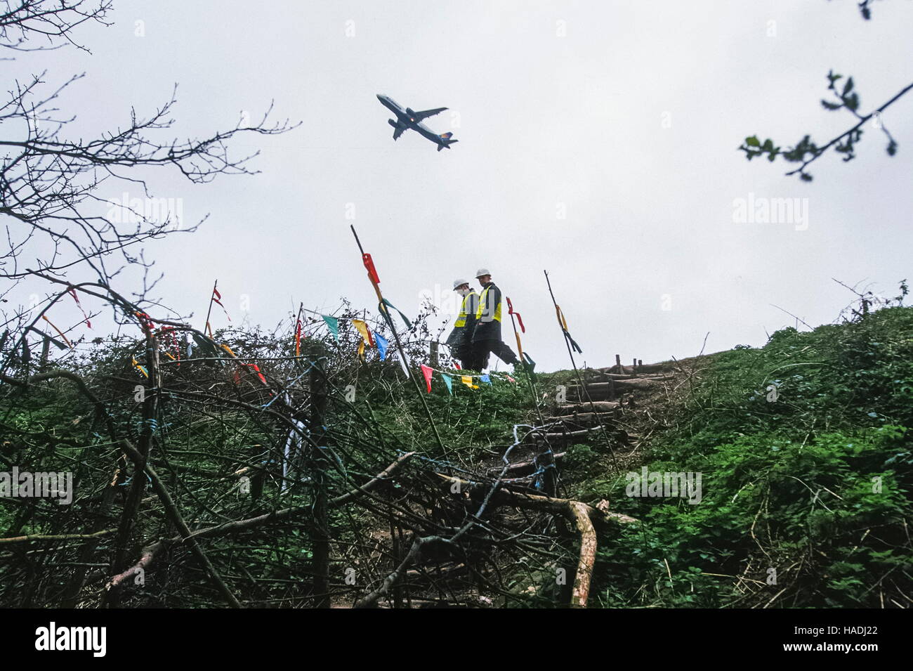 Private security walk past the Manchester Airport runway protest site