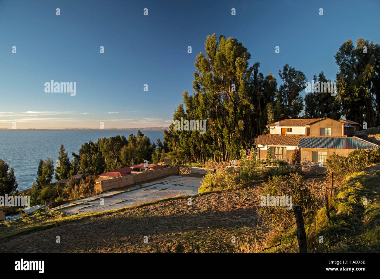 Houses, agricultural field and lake, Amantani Island, Lake Titicaca, Puno, Peru Stock Photo