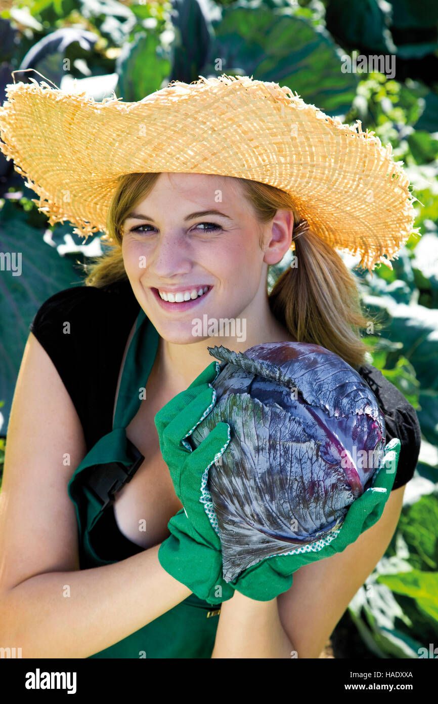 Female gardener with red cabbage Stock Photo