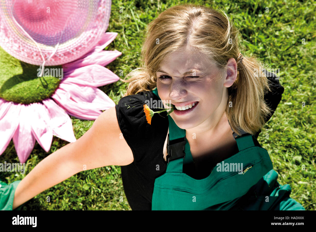 Female gardener with flower in her mouth Stock Photo