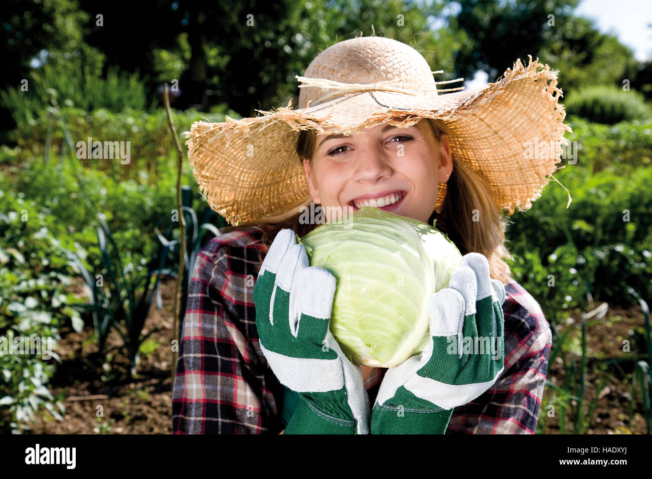 Young female gardener with white cabbage Stock Photo