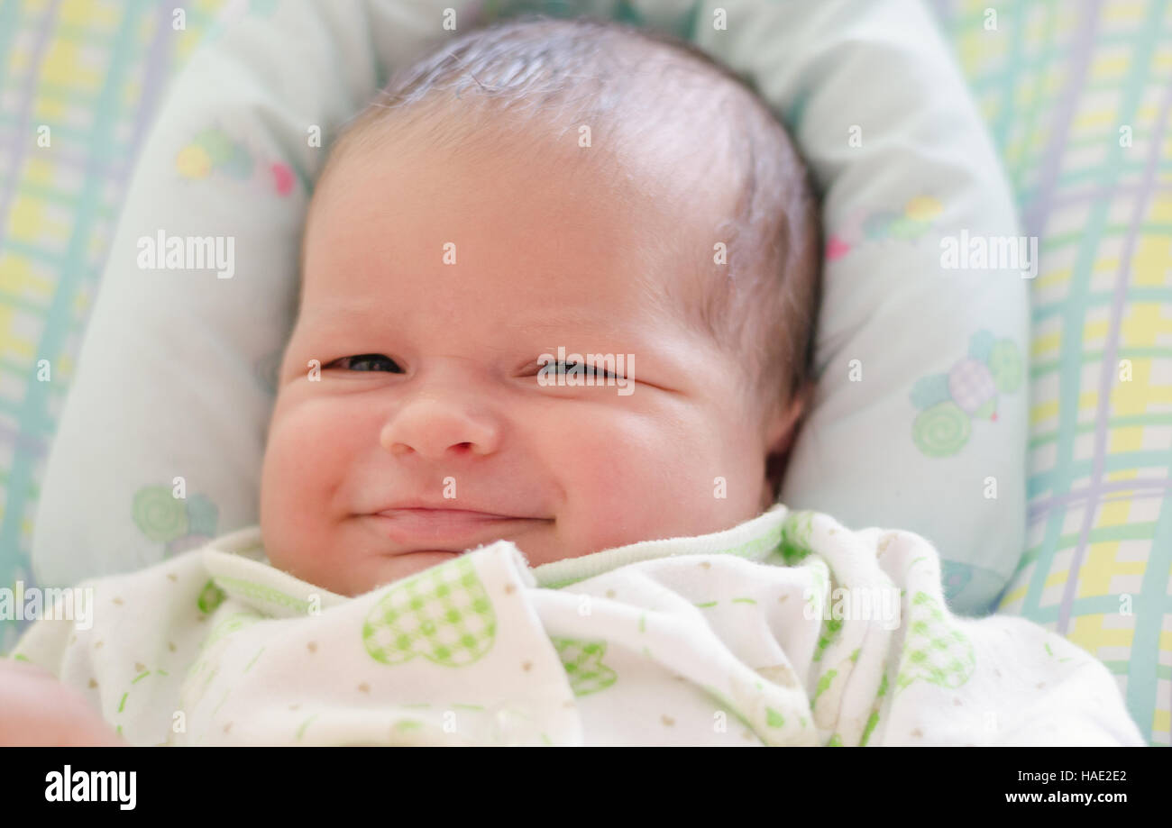 Beautiful newborn baby smiling and laughing. Soft focus Stock Photo