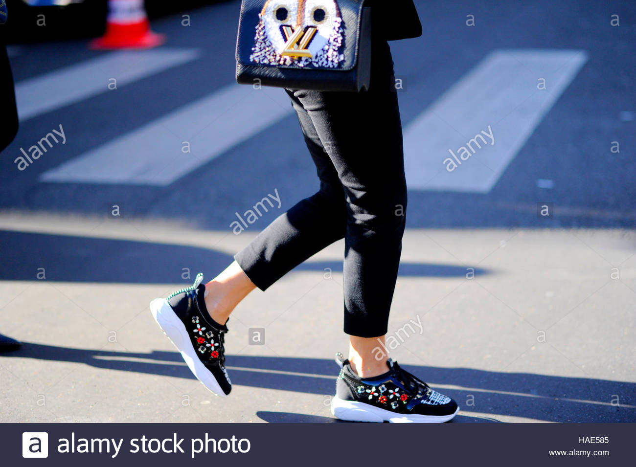 Detail of woman wearing Louis Vuitton sneakers and bag, at Place Stock Photo: 126930613 - Alamy