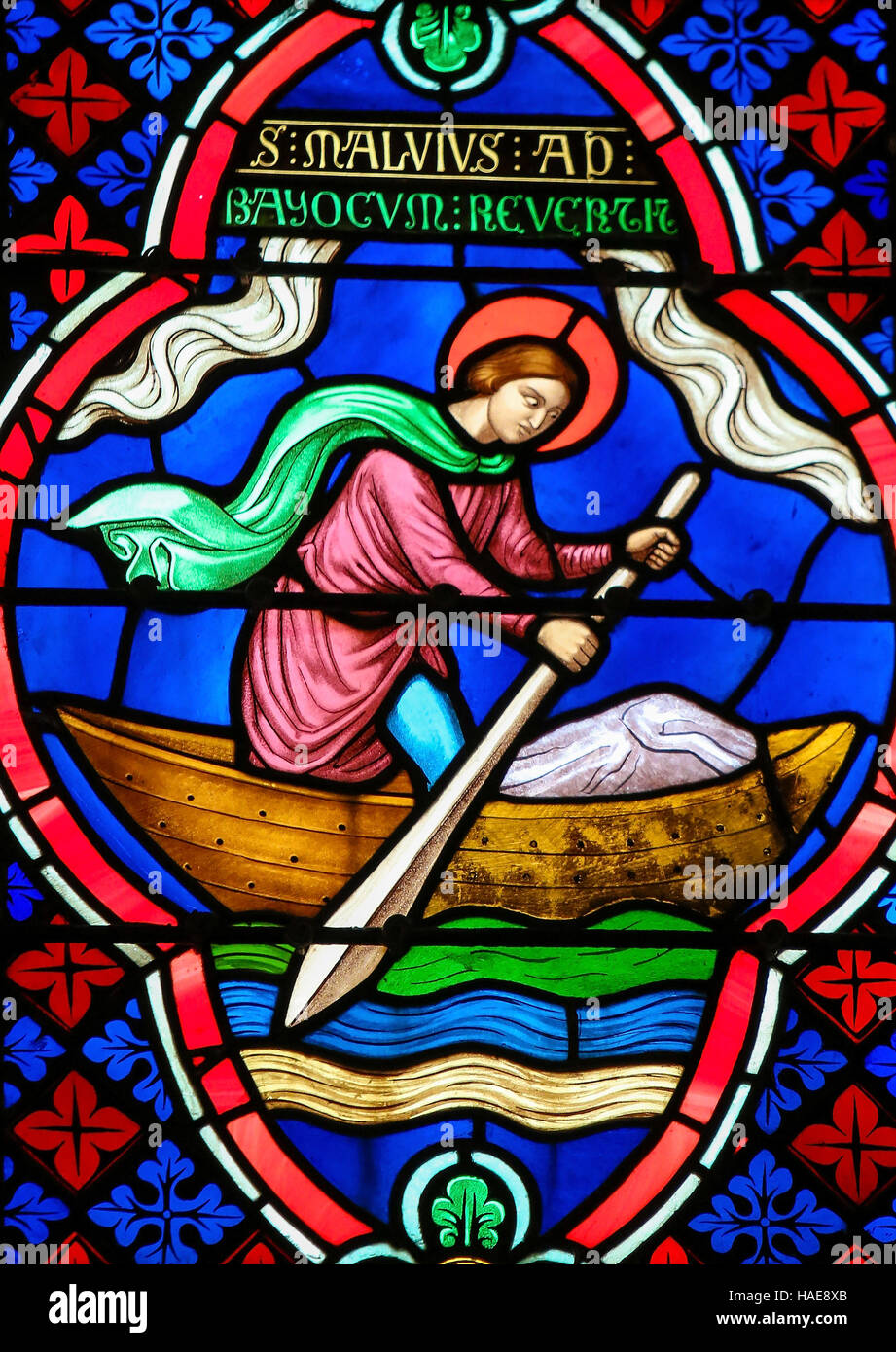 Stained Glass window in the Cathedral of Bayeux, France, depicting Saint Manveus or Manvieu, 5th century bishop of Bayeux, in a rowing boat returning Stock Photo