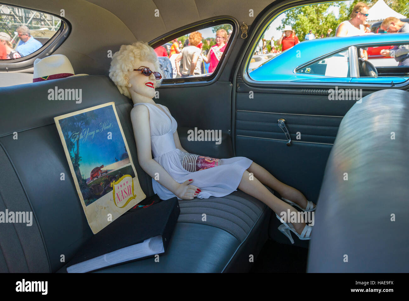 Life size Marilyn Monroe doll in back seat of classic car. Stock Photo