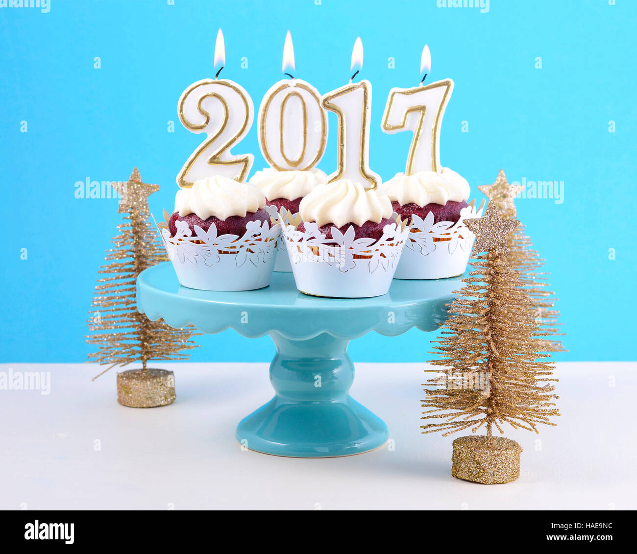 Happy New Year Cupcakes With 17 Candles In A Blue Gold And White Winter Theme Setting Background On Cakestand With Gold Christmas Trees Stock Photo Alamy